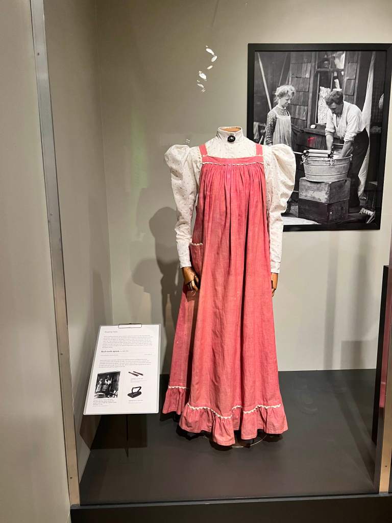 Red cotton chambray apron 1895 from What Women Wore at The New York Historical