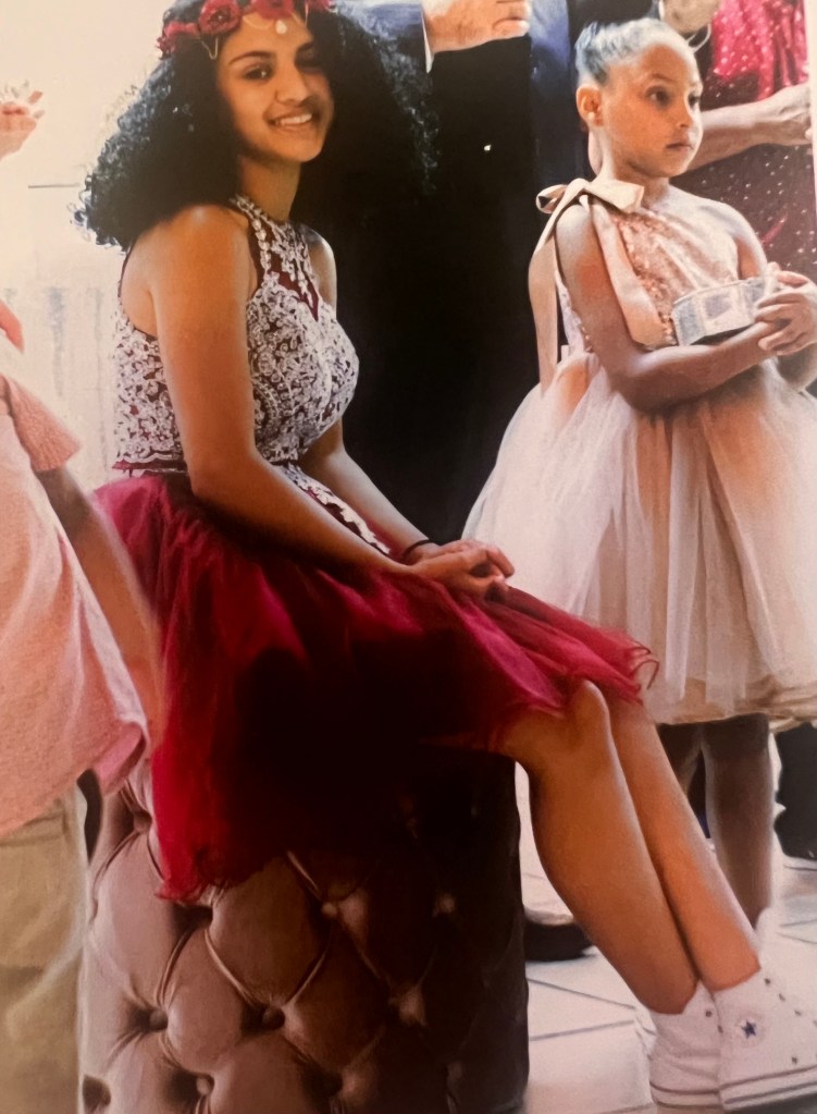 The young girl wearing her quinceanera dress with a pair of Converse sneakers